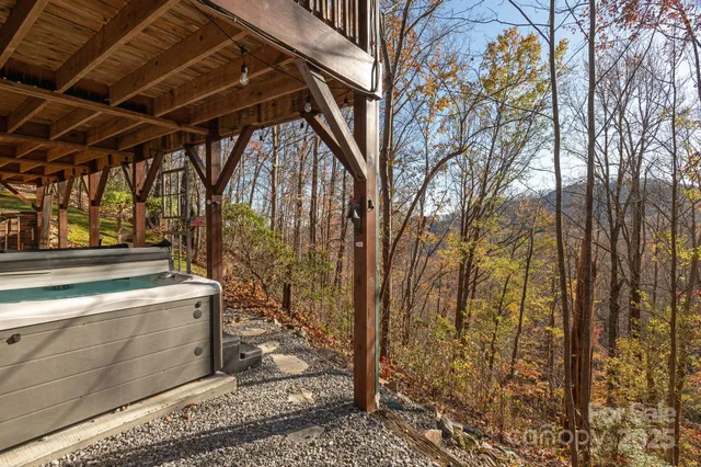 a view of a patio with wooden chairs