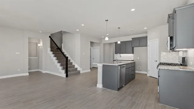 a kitchen with a sink appliances and cabinets