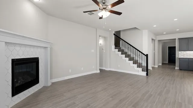 a large kitchen with a large counter top space a sink stainless steel appliances and cabinets