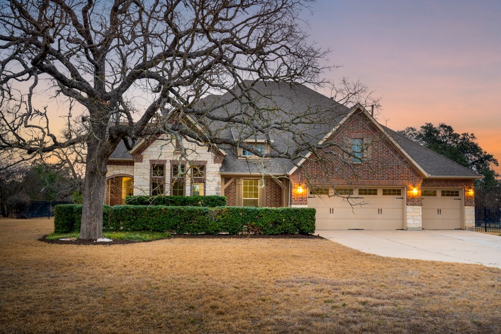 a front view of a house with a yard and garage