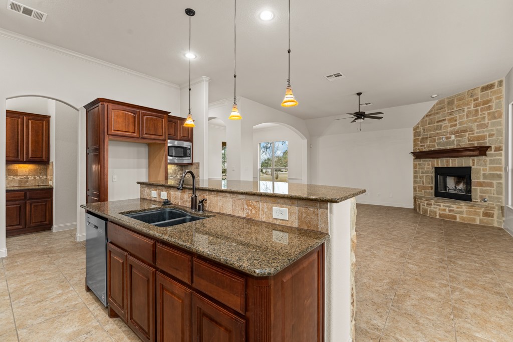 651 Shelf Rock Road Driftwood, TX 78619 - Photo 12 of 38 a kitchen with stainless steel appliances granite countertop a sink a oven and a kitchen island