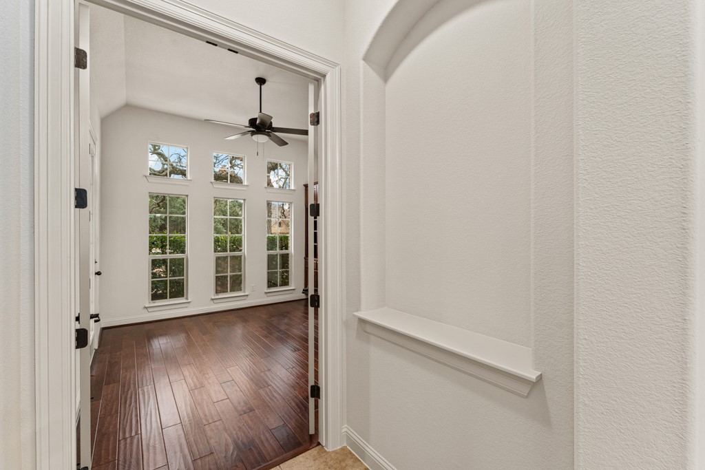 651 Shelf Rock Road Driftwood, TX 78619 - Photo 16 of 38 a view of a hallway with wooden floor and a window