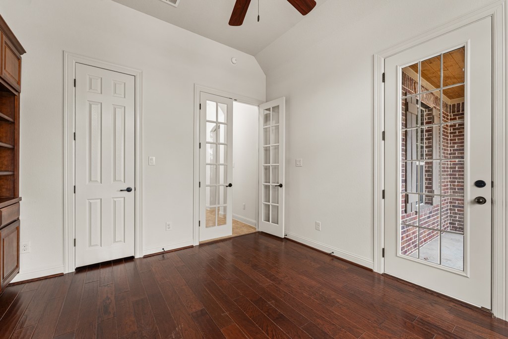 651 Shelf Rock Road Driftwood, TX 78619 - Photo 18 of 38 a view of an empty room with wooden floor and a window