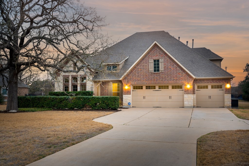 651 Shelf Rock Road Driftwood, TX 78619 - Photo 2 of 38 a front view of a house with a yard and garage