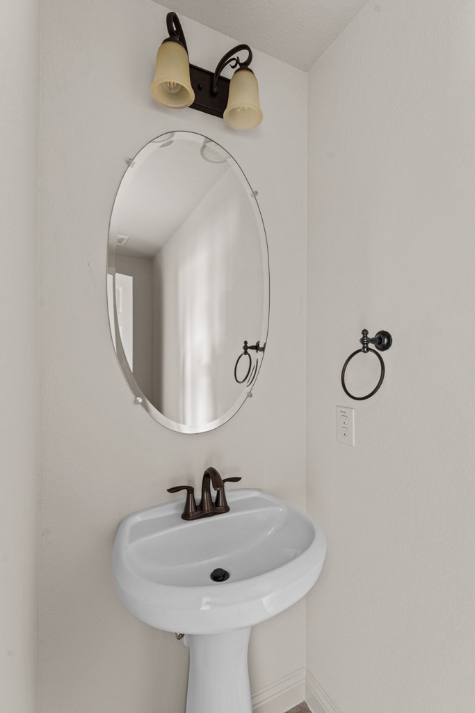 651 Shelf Rock Road Driftwood, TX 78619 - Photo 30 of 38 a bathroom with a sink and mirror