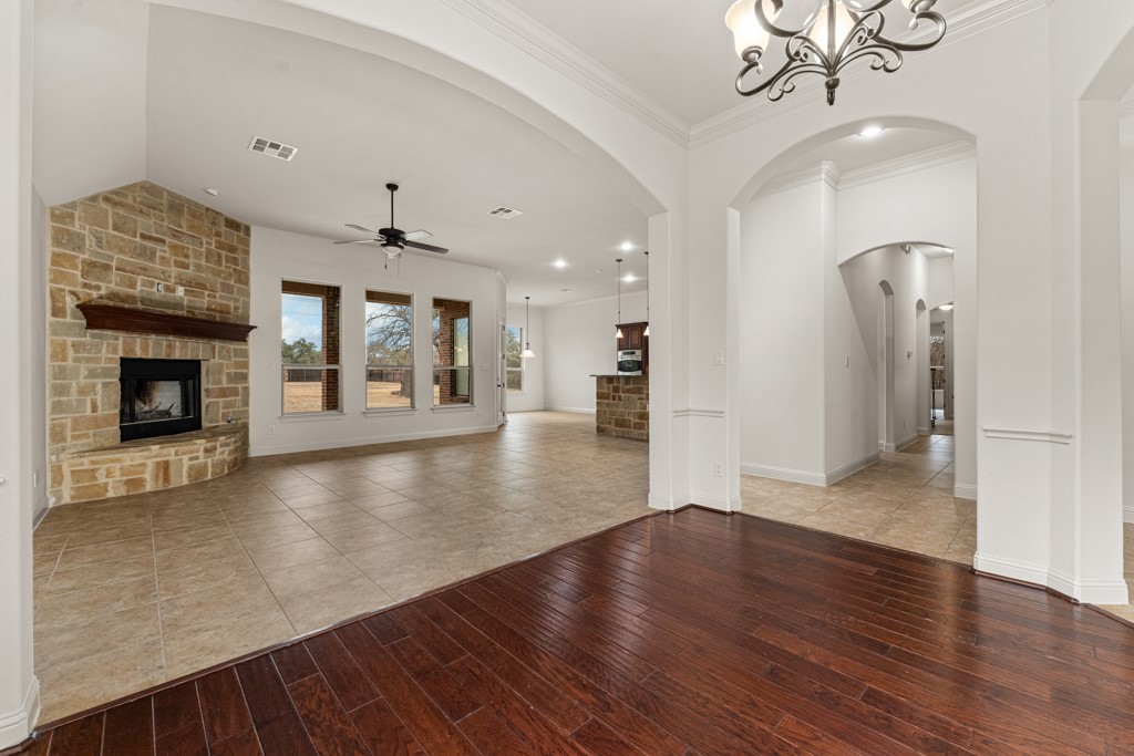651 Shelf Rock Road Driftwood, TX 78619 - Photo 6 of 38 a view of a livingroom with wooden floor and a fireplace