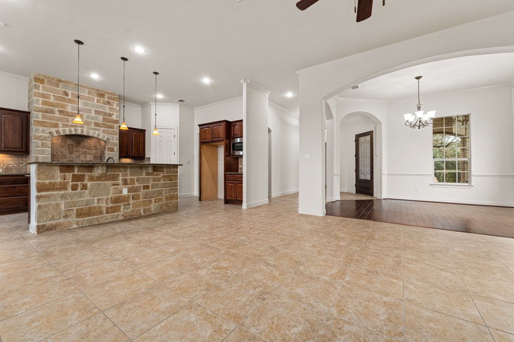 651 Shelf Rock Road Driftwood, TX 78619 - Photo 37 of 38 a view of an empty room with furniture and a flat screen tv