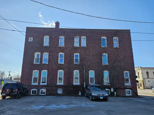 a bedroom with furniture and a flat screen tv