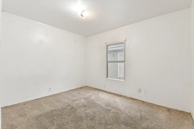 a view of a yard with wooden fence