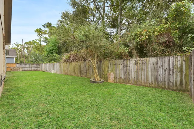 a view of backyard with garden and trees