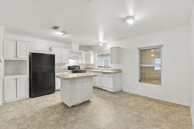 a kitchen with a refrigerator and a sink