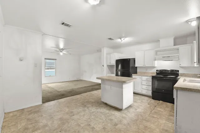 a kitchen with a sink stainless steel appliances and cabinets