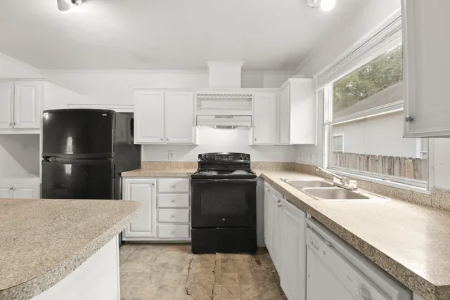 a kitchen with a sink stove and refrigerator