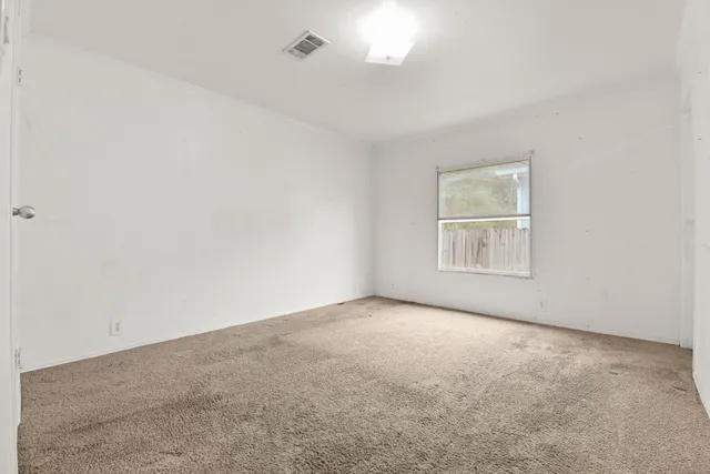 an empty room with a empty space and windows