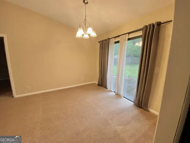 a view of empty room with a mirror