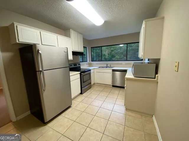 a kitchen with a refrigerator sink and stove