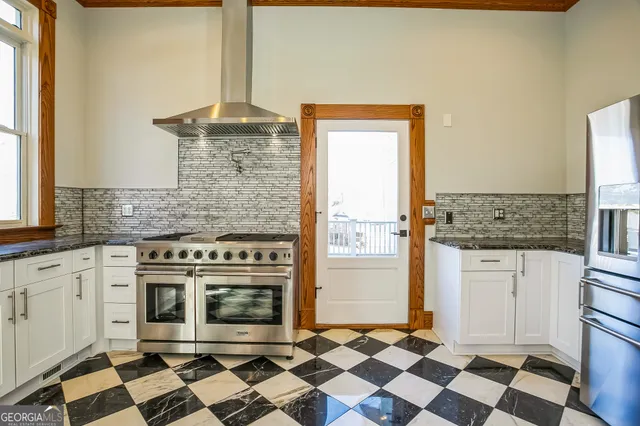 a kitchen with a stove a sink and a refrigerator