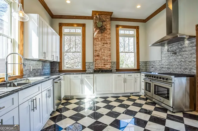 a kitchen with a checkered floor and a stove top oven