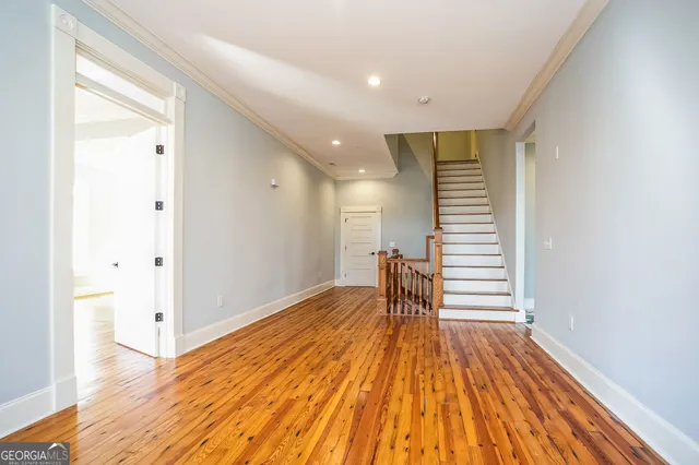 a view of a room with wooden floor