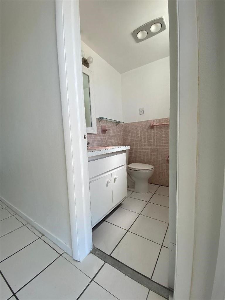 1855 Plunkett Street, Unit 101 Hollywood, FL 33020 - Photo 14 of 25 a spacious bathroom with a toilet sink and mirror