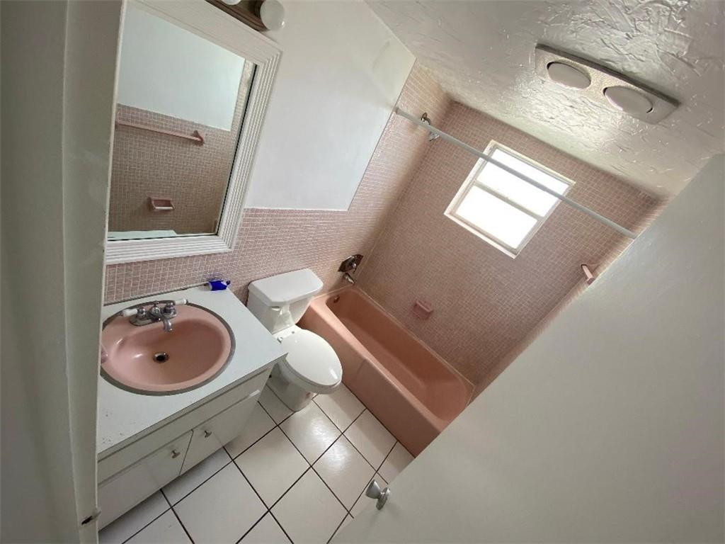 1855 Plunkett Street, Unit 101 Hollywood, FL 33020 - Photo 15 of 25 a bathroom with a sink and a toilet