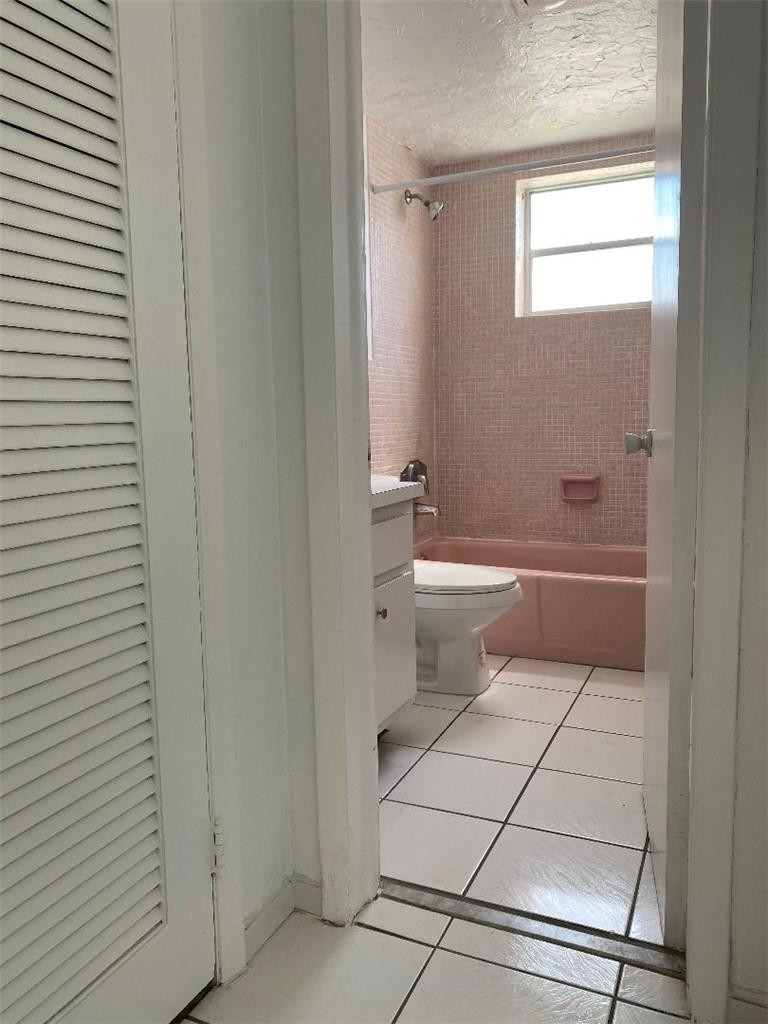 1855 Plunkett Street, Unit 101 Hollywood, FL 33020 - Photo 19 of 25 a bathroom with a toilet a sink and shower