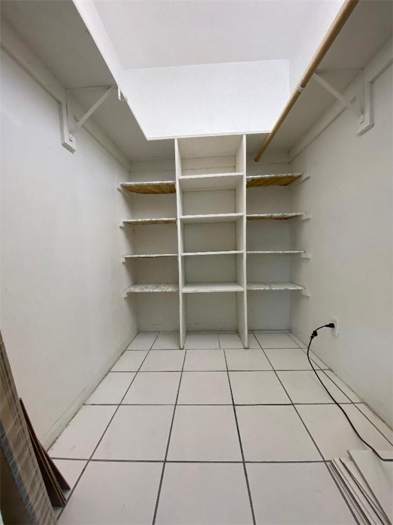 1855 Plunkett Street, Unit 101 Hollywood, FL 33020 - Photo 22 of 25 a view of a room with shelves