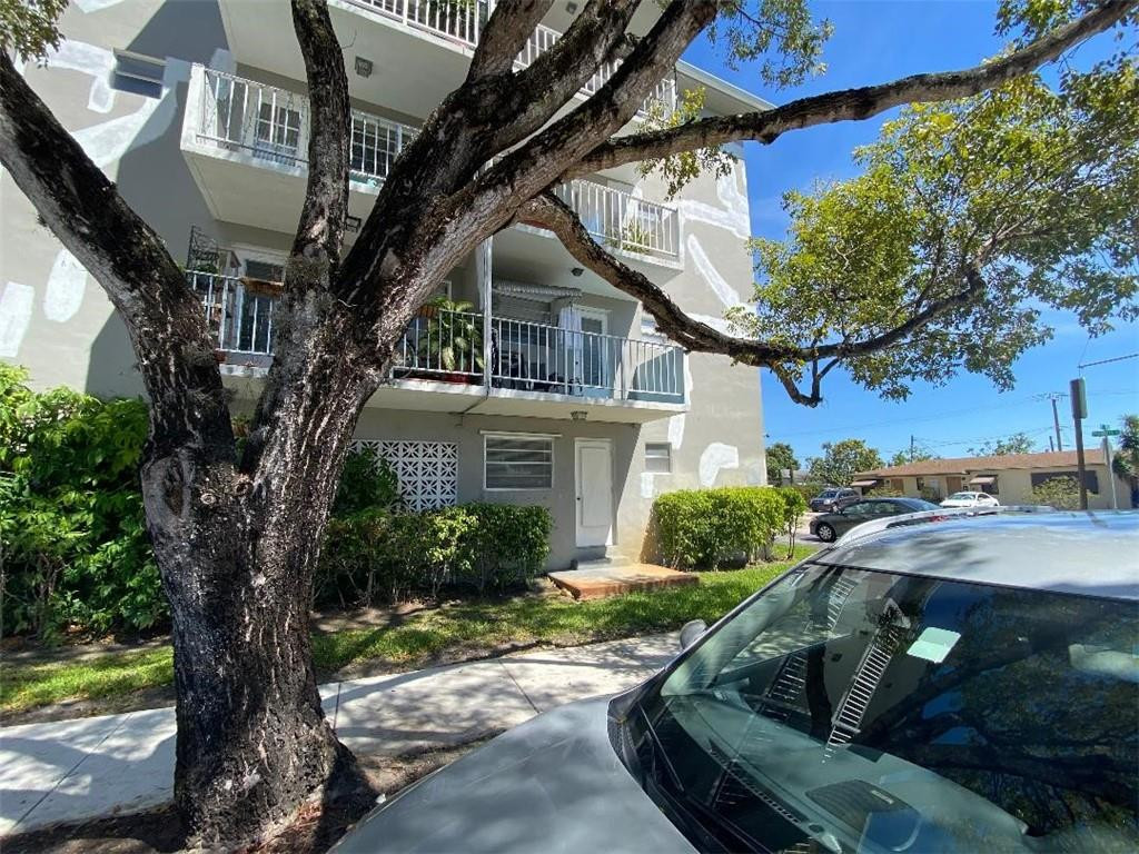1855 Plunkett Street, Unit 101 Hollywood, FL 33020 - Photo 24 of 25 a view of a house with a tree in front of it