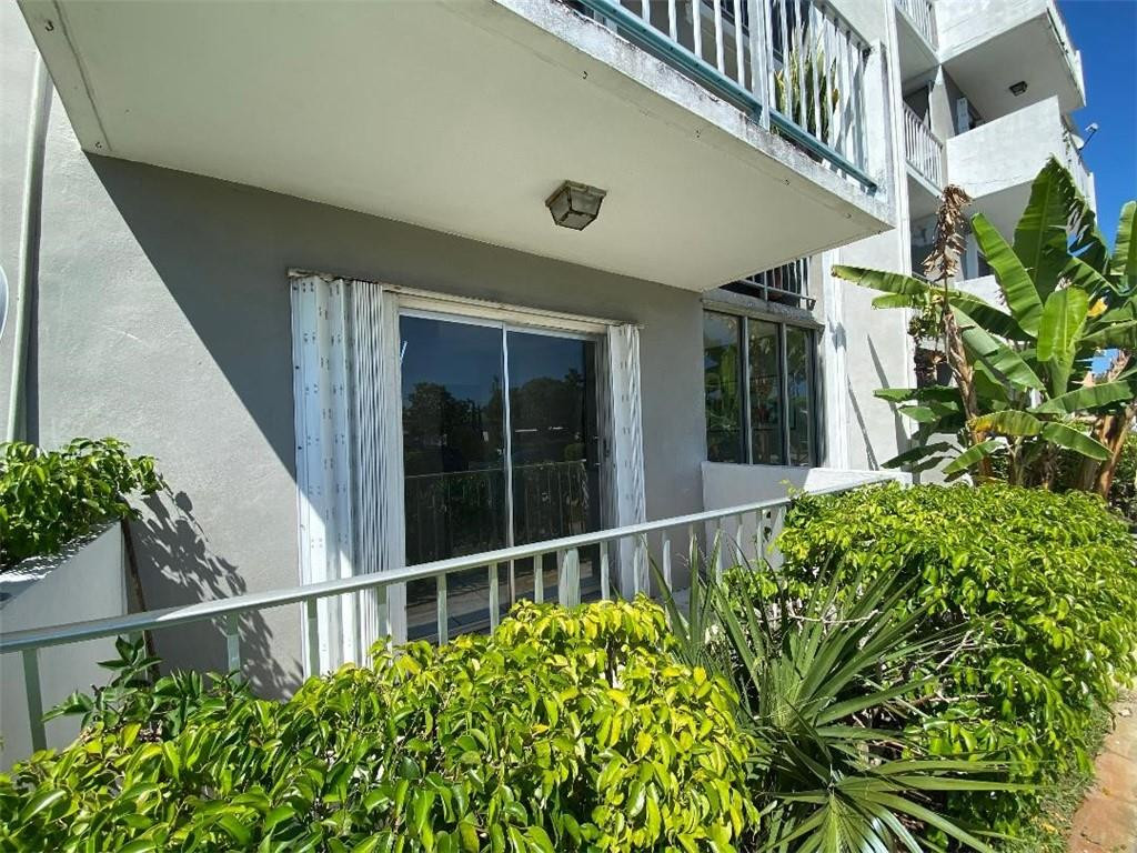 1855 Plunkett Street, Unit 101 Hollywood, FL 33020 - Photo 6 of 25 a house with a lot of flower in it