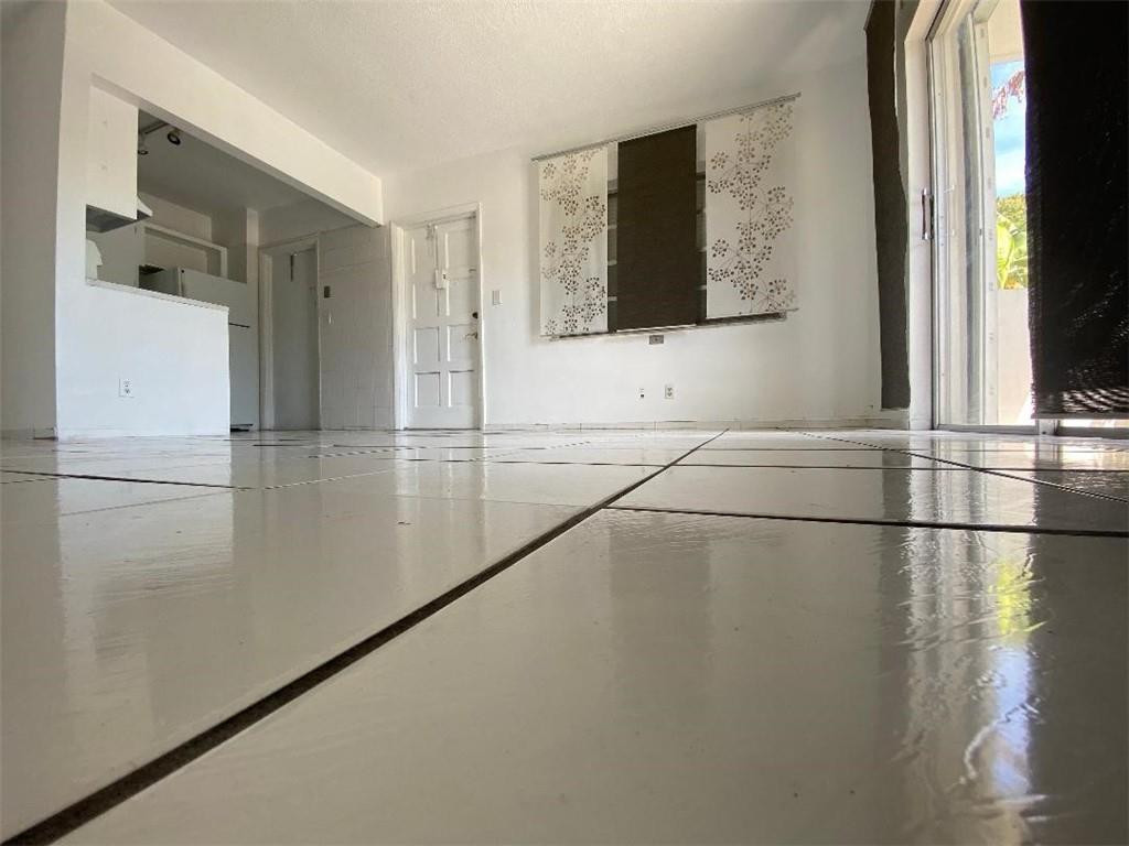 1855 Plunkett Street, Unit 101 Hollywood, FL 33020 - Photo 8 of 25 a view of a living room with a large window