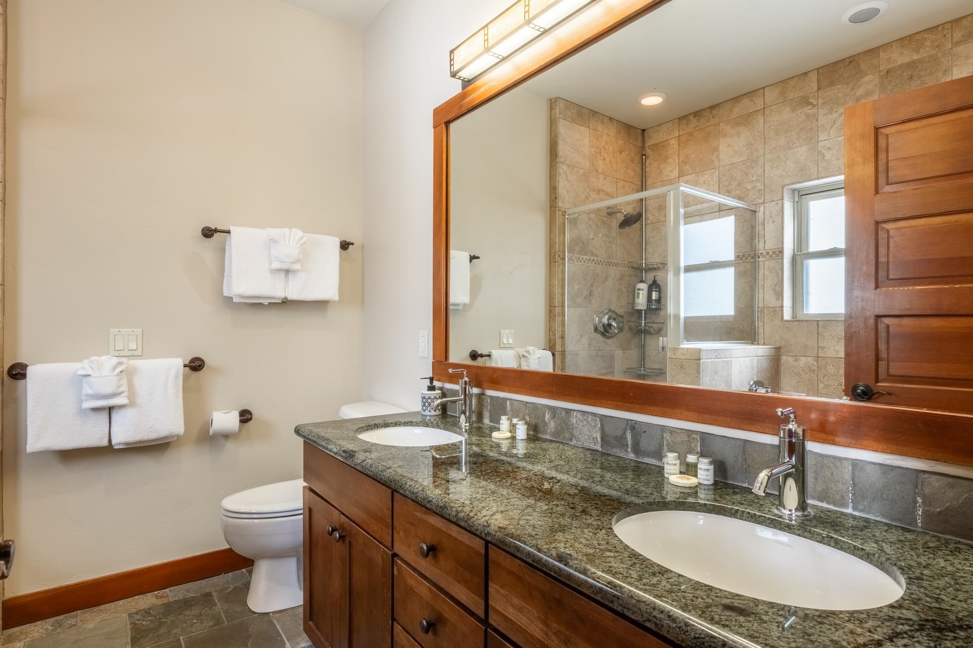 125 Davison Road, Unit 2 Mammoth Lakes, CA 93546 - Photo 25 of 50 a bathroom with a granite countertop sink toilet and mirror