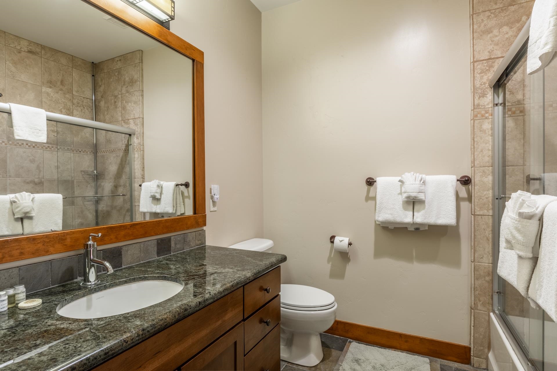 125 Davison Road, Unit 2 Mammoth Lakes, CA 93546 - Photo 30 of 50 a bathroom with a granite countertop sink toilet and mirror