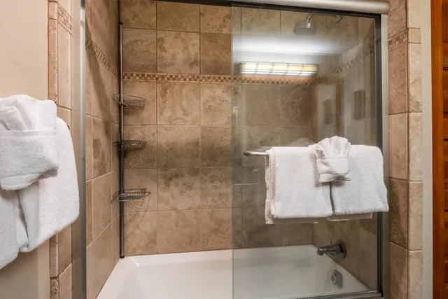 a bathroom with a bathtub and shower