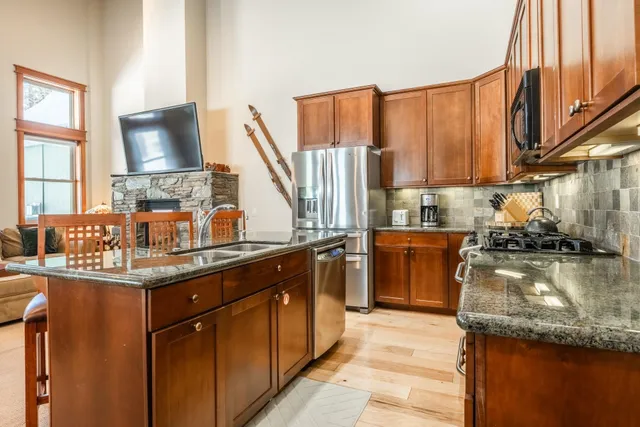 a kitchen with a sink stove and cabinets