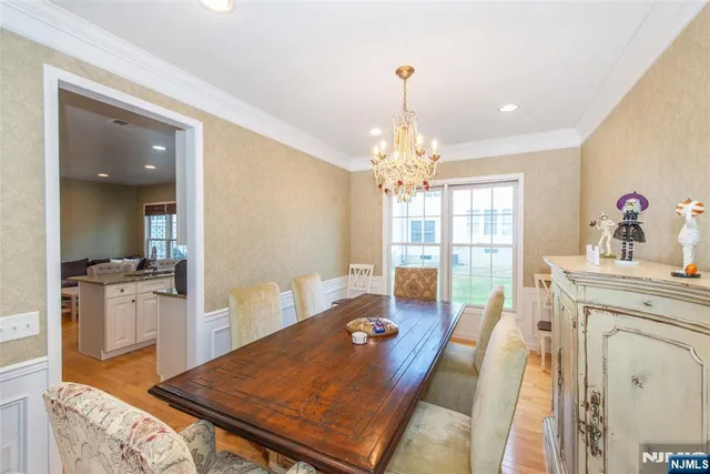 a very nice looking dining room with a table and chandelier