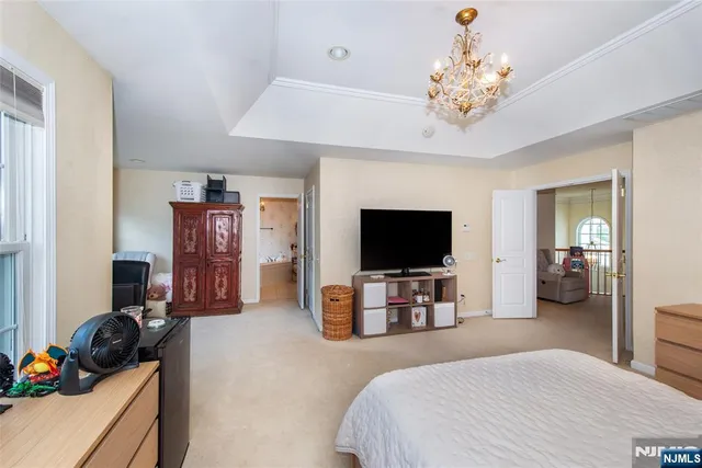 a bedroom with furniture and a flat screen tv