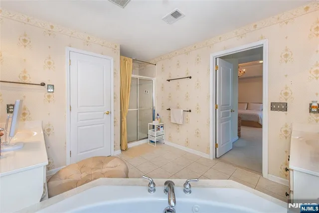 a bathroom with a tub shower and sink