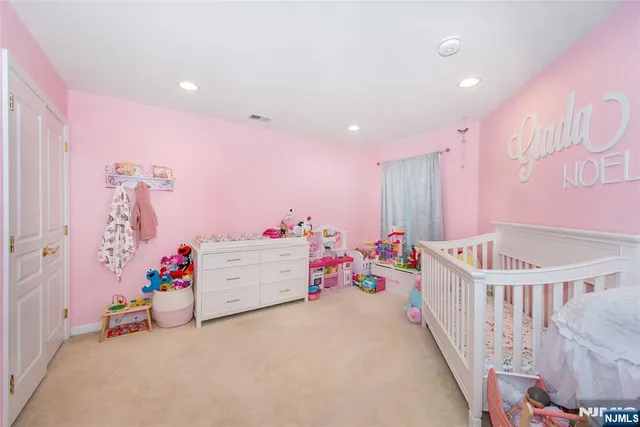 a bedroom with furniture and baby crib