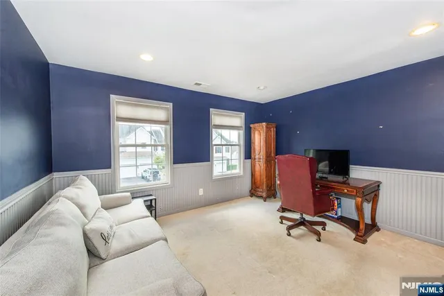 a view of a livingroom with workspace and a window