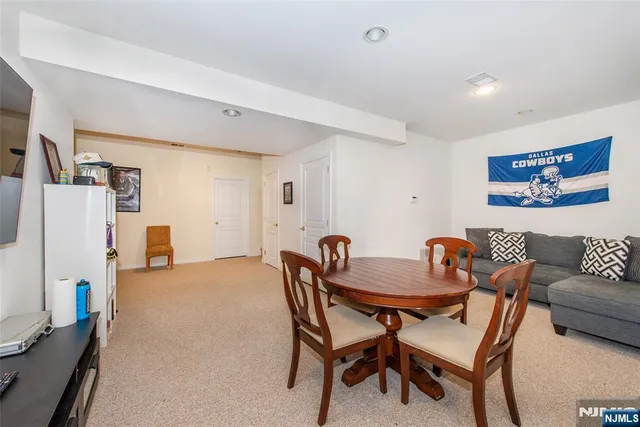 a dining room with furniture and a refrigerator