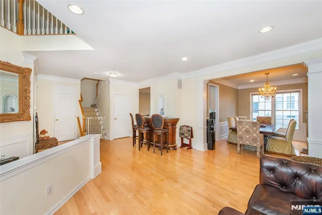 a living room with furniture kitchen view and a large window