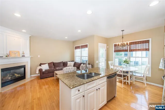 a living room with furniture a fireplace and a floor to ceiling window