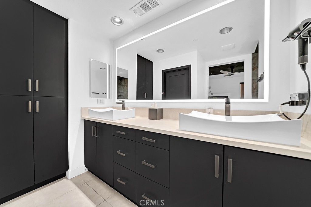 39 Gramercy Irvine, CA 92612 - Photo 13 of 48 a bathroom with a double vanity sink and a large mirror