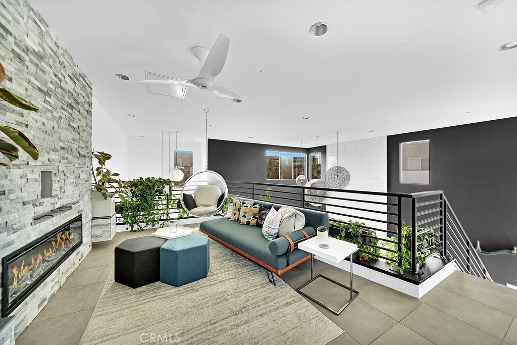 39 Gramercy Irvine, CA 92612 - Photo 22 of 48 a living room with furniture kitchen view and a fireplace