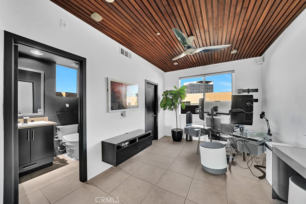 39 Gramercy Irvine, CA 92612 - Photo 26 of 48 a very nice looking open kitchen with stainless steel appliances kitchen island granite countertop a table chairs in it and a window