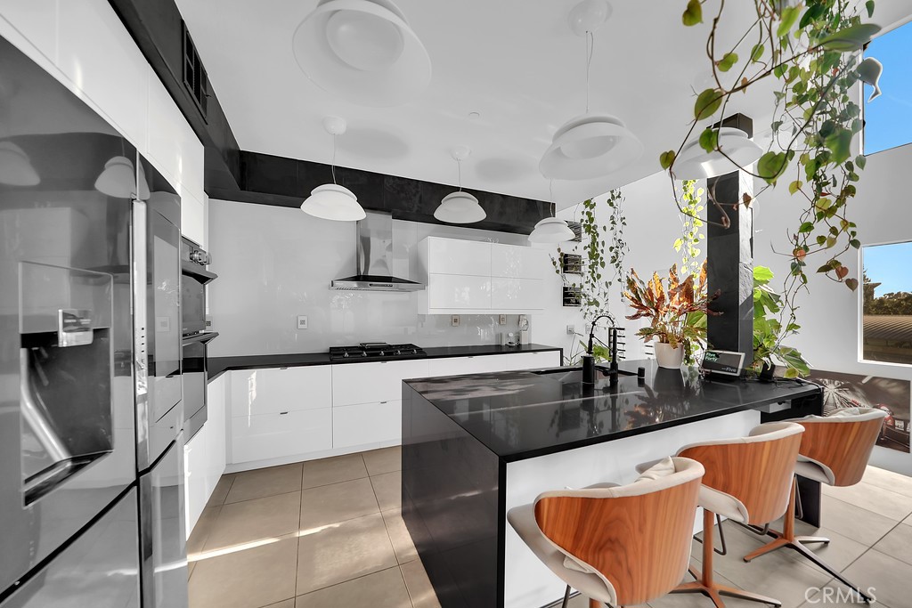 39 Gramercy Irvine, CA 92612 - Photo 6 of 48 a kitchen with stainless steel appliances granite countertop a sink and a stove