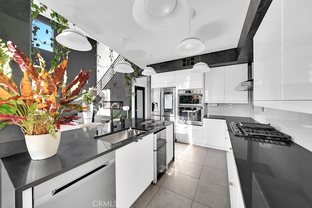 39 Gramercy Irvine, CA 92612 - Photo 7 of 48 a kitchen with stainless steel appliances kitchen island granite countertop a sink and cabinets