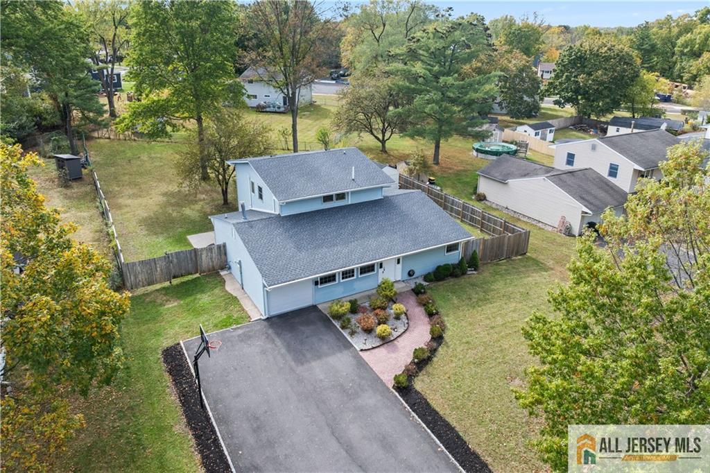 an aerial view of a house with garden space and street view