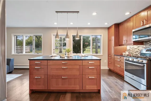 a kitchen with stainless steel appliances granite countertop a stove and a sink