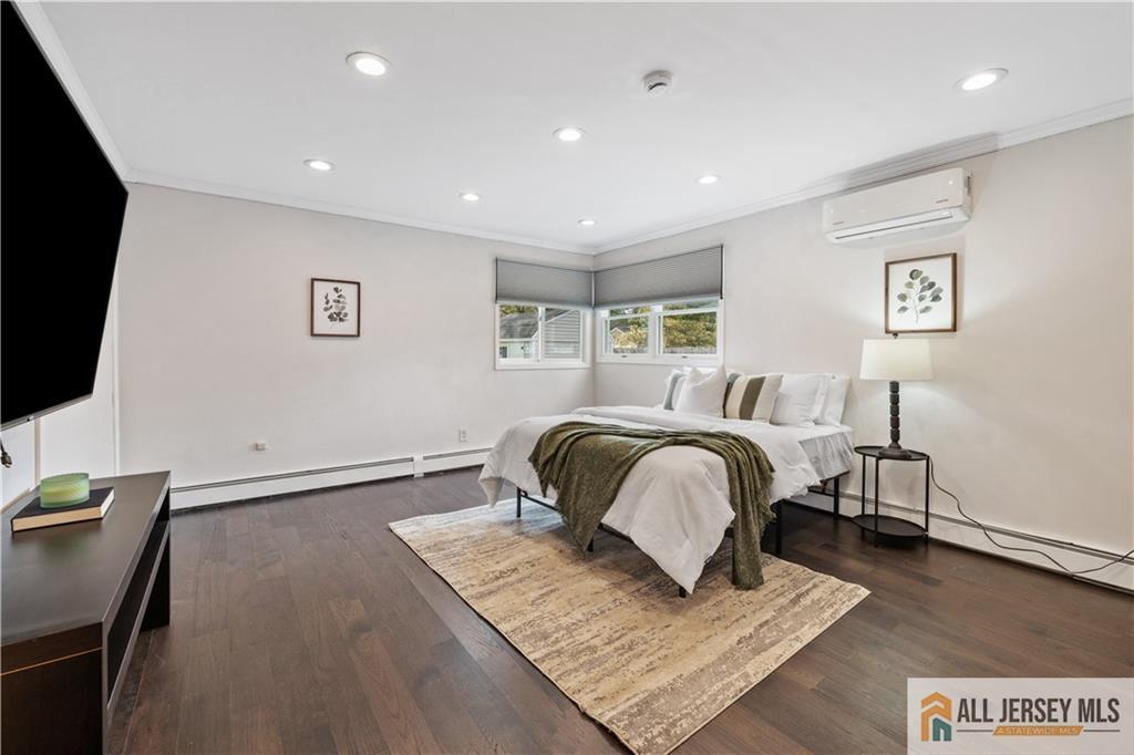 35 Emerald Road Kendall Park, NJ 08824 - Photo 20 of 37 a bedroom with a bed and a flat screen tv